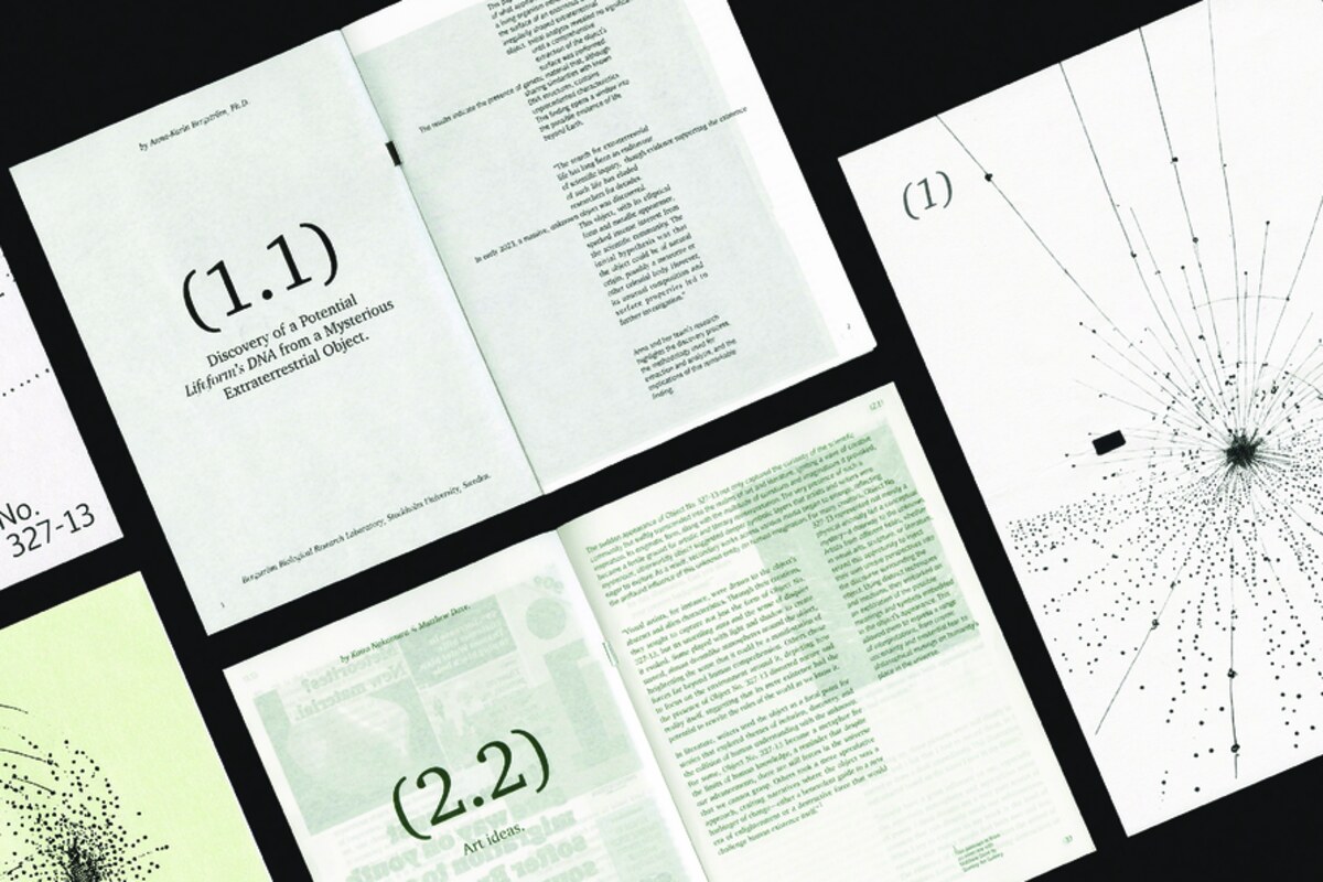Printed book spreads laid out on black, showing dot-field diagrams and typographic pages